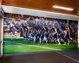 Custom football mural in Villanova University's athletic building.