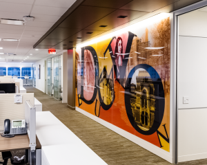 Acrylic glass panels with vinyl prints can break up blank office walls